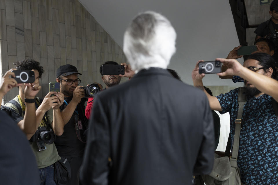 Journalists photograph Guatemalan journalist Jose Ruben Zamora, founder of El Periodico newspaper, as he arrives to court in handcuffs for a hearing in Guatemala City, Wednesday, May 15, 2024. Zamora has been jailed for almost two years and seeks his release. (AP Photo/Moises Castillo)