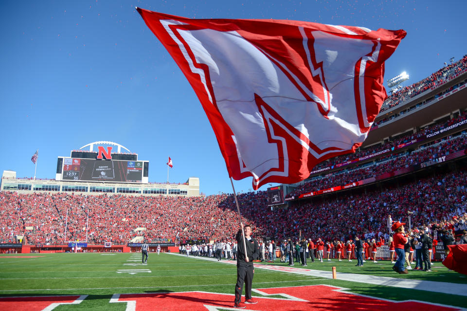 LINCOLN, NE - OCTOBER 27: A flag bearer for the Nebraska Cornhuskers waves the flag after a touchdown against the Bethune Cookman Wildcats at Memorial Stadium on October 27, 2018 in Lincoln, Nebraska. (Photo by Steven Branscombe/Getty Images)