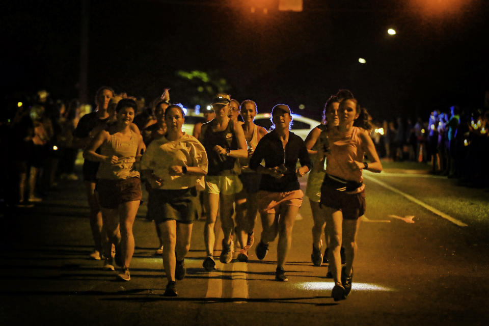 Thousands of runners, supporters and mourners attend a 4:20 a.m "Let's Finish Liza's Run" event in honor of Eliza Fletcher on Friday, Sept. 9, 2022 in Memphis, Tenn. Fletcher, was kidnapped and murder while running last week. (Mark Weber/Daily Memphian via AP)