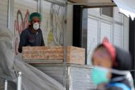 Palestinian man, wearing a mask as a preventive measure against the coronavirus disease, looks on as he works at a bakery in Gaza City