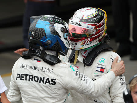 Formula One F1 - Brazilian Grand Prix - Autodromo Jose Carlos Pace, Interlagos, Sao Paulo, Brazil - November 11, 2018 Mercedes' Lewis Hamilton celebrates winning the race with Mercedes' Valtteri Bottas REUTERS/Paulo Whitaker