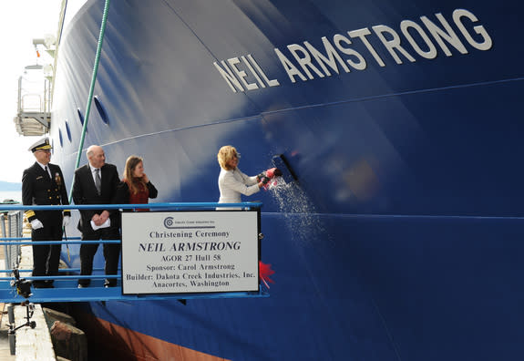 Carol Armstrong, ship's sponsor for the Auxiliary General Oceanographic Research (AGOR) research vessel (R/V) Neil Armstrong (AGOR 27), breaks a bottle across the bow during a christening ceremony at Dakota Creek Industries, Inc. shipyard in An
