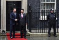 China's President Xi Jinping is welcomed by Britain's Prime Minister David Cameron at 10 Downing Street, in central London, Britain, October 21, 2015. Xi is on a state visit to Britain. REUTERS/Toby Melville