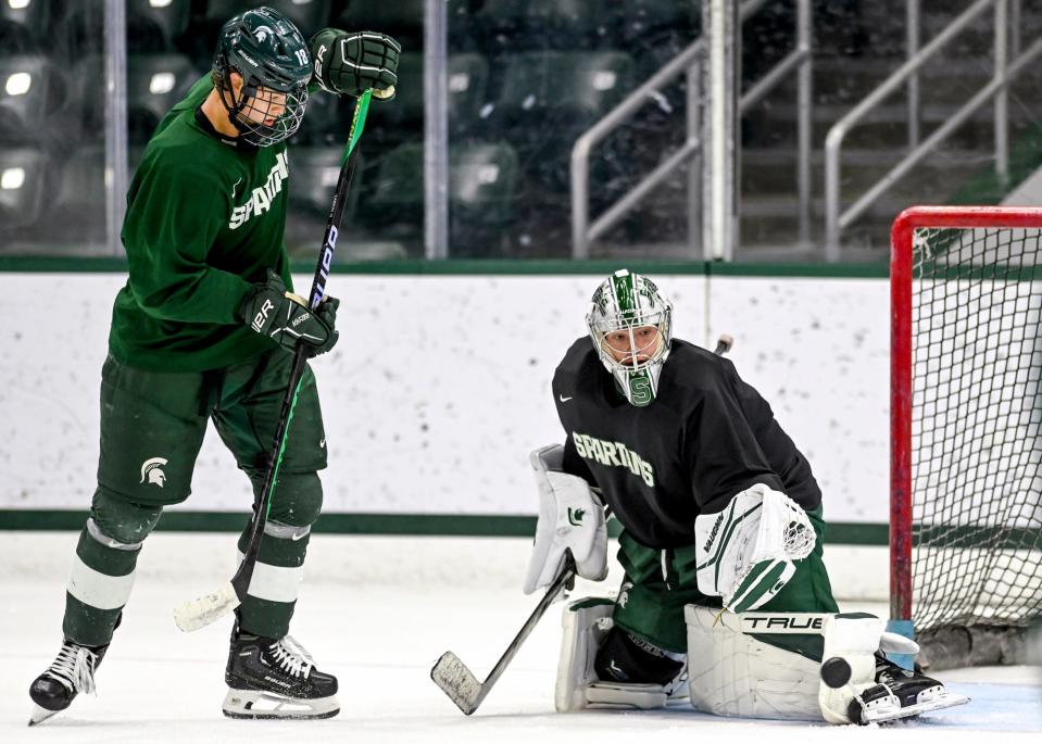 Michigan State's goalie Trey Augustine, right, defends as Joey Larson tries to get a puck past him in practice during hockey media day on Wednesday, Sept. 27, 2023, at Munn Arena in East Lansing.