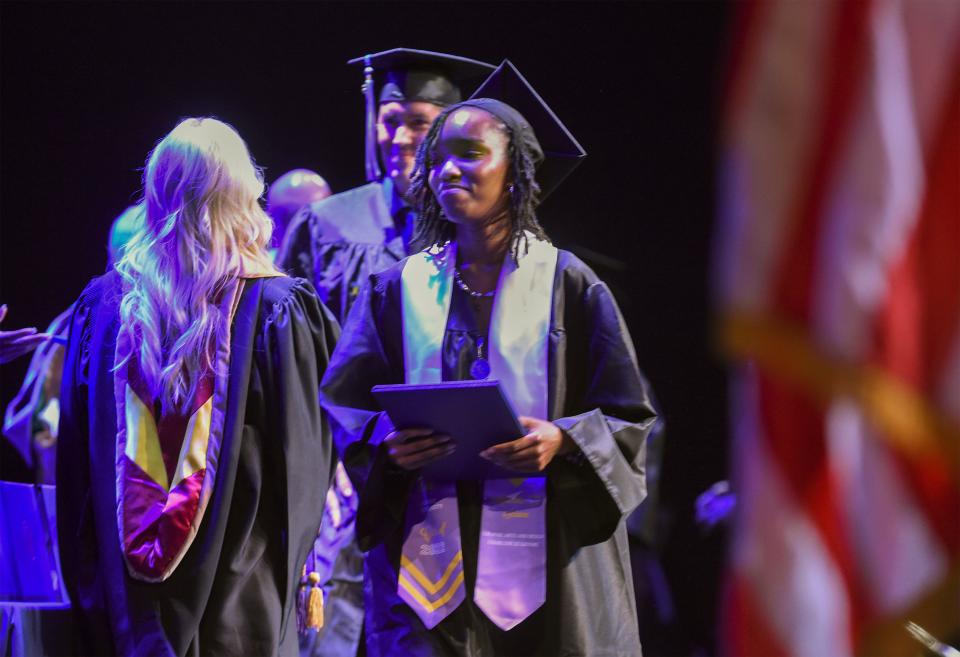 Charlene Le Gendre walks off the stage after receiving her Associate of Science degree in Graphic Art and Design during Keiser University's commencement ceremony at Westside Church on Friday, June 2, 2023, in Fort Pierce.