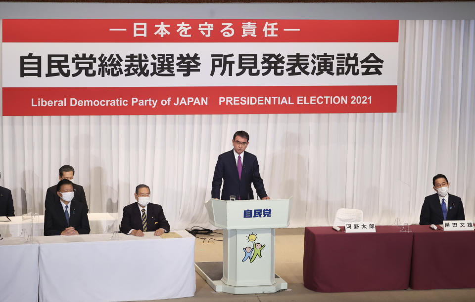 Taro Kono, a candidate of the ruling Liberal Democratic Party (LDP) presidential election and currently the minister in charge of vaccinations, delivers a campaign speech while another candidate former Foreign Minister Fumio Kishida, right, listens to him in Tokyo Friday, Sept. 17, 2021. Official election campaigning kicked off Friday for the new head of Japan's governing Liberal Democratic Party, whose winner is almost assured to become next Japanese prime minister.(Yoshikazu Tsuno/Pool Photo via AP)