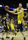 Michigan guard Nik Stauskas (11) goes to the basket against Wofford during the first half of a second round NCAA college basketball tournament game Thursday, March 20, 2014, in Milwaukee. (AP Photo/Morry Gash)