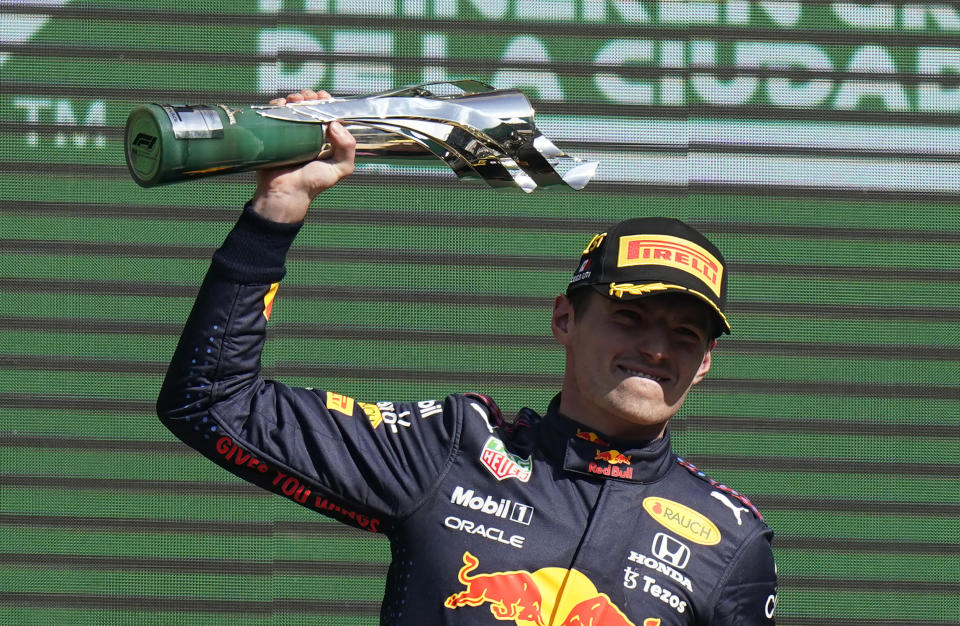 Red Bull driver Max Verstappen, of The Netherlands, celebrates with the trophy after winning the Formula One Mexico Grand Prix auto race at the Hermanos Rodriguez racetrack in Mexico City, Sunday, Nov. 7, 2021. (AP Photo/Eduardo Verdugo)