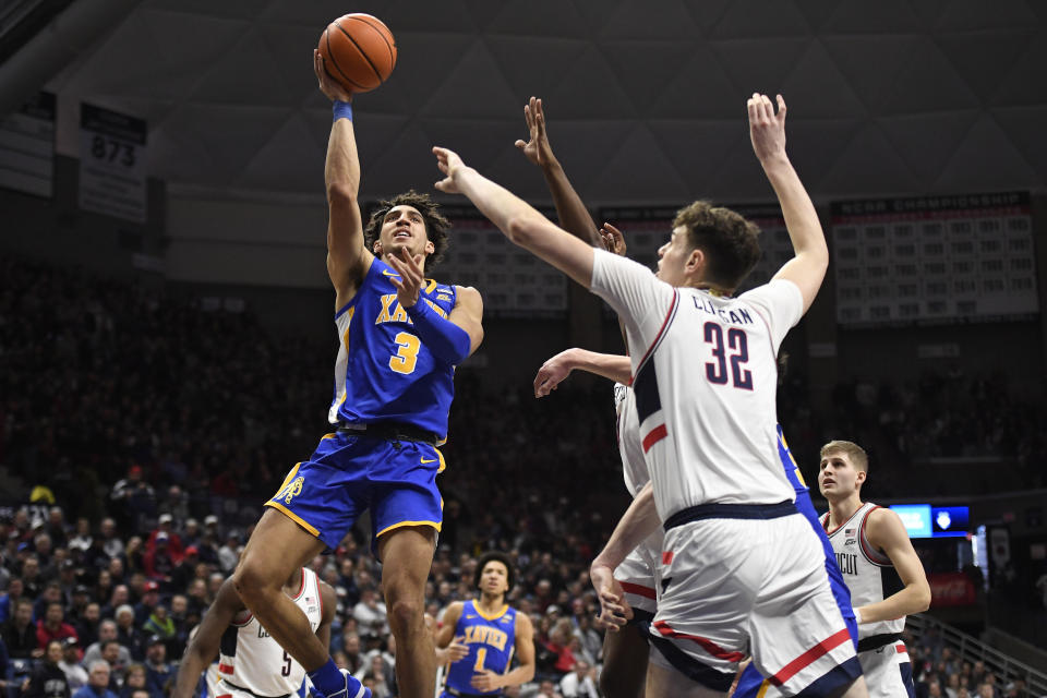 Xavier's Colby Jones (3) shoots over UConn's Donovan Clingan (32) in the first half of an NCAA college basketball game, Wednesday, Jan. 25, 2023, in Storrs, Conn. (AP Photo/Jessica Hill)