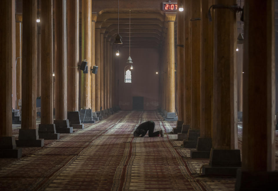 A Kashmiri man offers prayer inside the Jamia Masjid, or the grand mosque in Srinagar, Indian controlled Kashmir, Nov. 13, 2021. The mosque has remained out of bounds to worshippers for prayers on Friday – the main day of worship in Islam. Indian authorities see it as a trouble spot, a nerve center for anti-India protests and clashes that challenge New Delhi’s sovereignty over disputed Kashmir. For Kashmiri Muslims it is a symbol of faith, a sacred place where they offer not just mandatory Friday prayers but also raise their voice for political rights. (AP Photo/Mukhtar Khan)