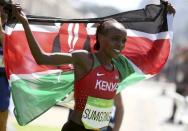 2016 Rio Olympics - Athletics - Final - Women's Marathon -Sambodromo - Rio de Janeiro, Brazil - 14/08/2016. Jemima Sumgong (KEN) of Kenya celebrates after winning the race REUTERS/Sergio Moraes