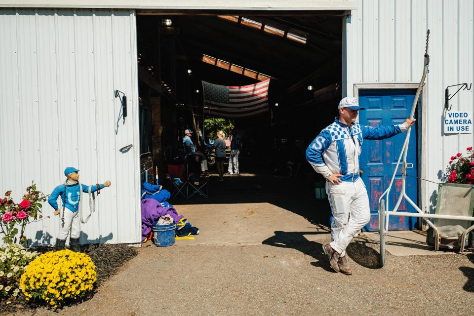 Harness racer Isaac Shrake, from Canton, takes in warmups before at the Tuscarawas County Fair.