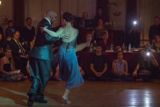 Stage tango world champion Maria Noel Sciuto (R), dances with Rodrigo Fleitas during an exhibition at Chamuyo milonga in Montevideo on April 29, 2018