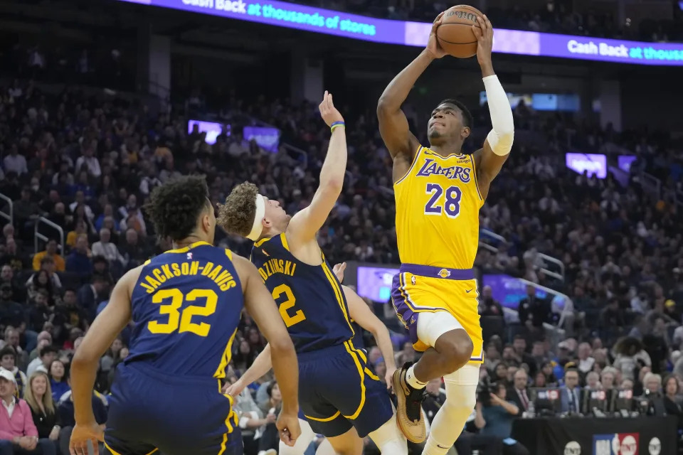 Los Angeles Lakers forward Rui Hachimura (28) shoots against Golden State Warriors forward Trayce Jackson-Davis (32) and guard Brandin Podziemski (2) during the first half of an NBA basketball game in San Francisco, Thursday, Feb. 22, 2024. (AP Photo/Jeff Chiu)