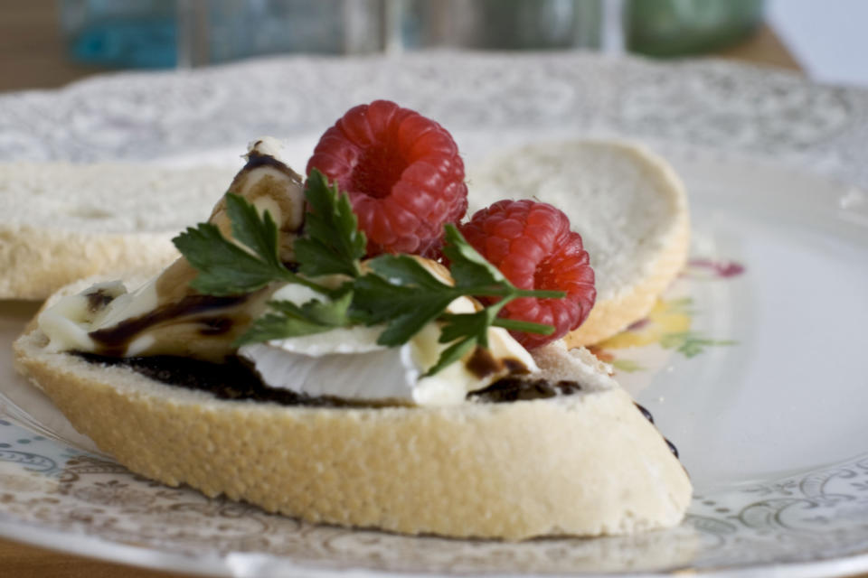 In this image taken on Monday, November 26, 2012, brie with bourbon-balsamic glaze is shown served on a plate in Concord, N.H. (AP Photo/Matthew Mead)