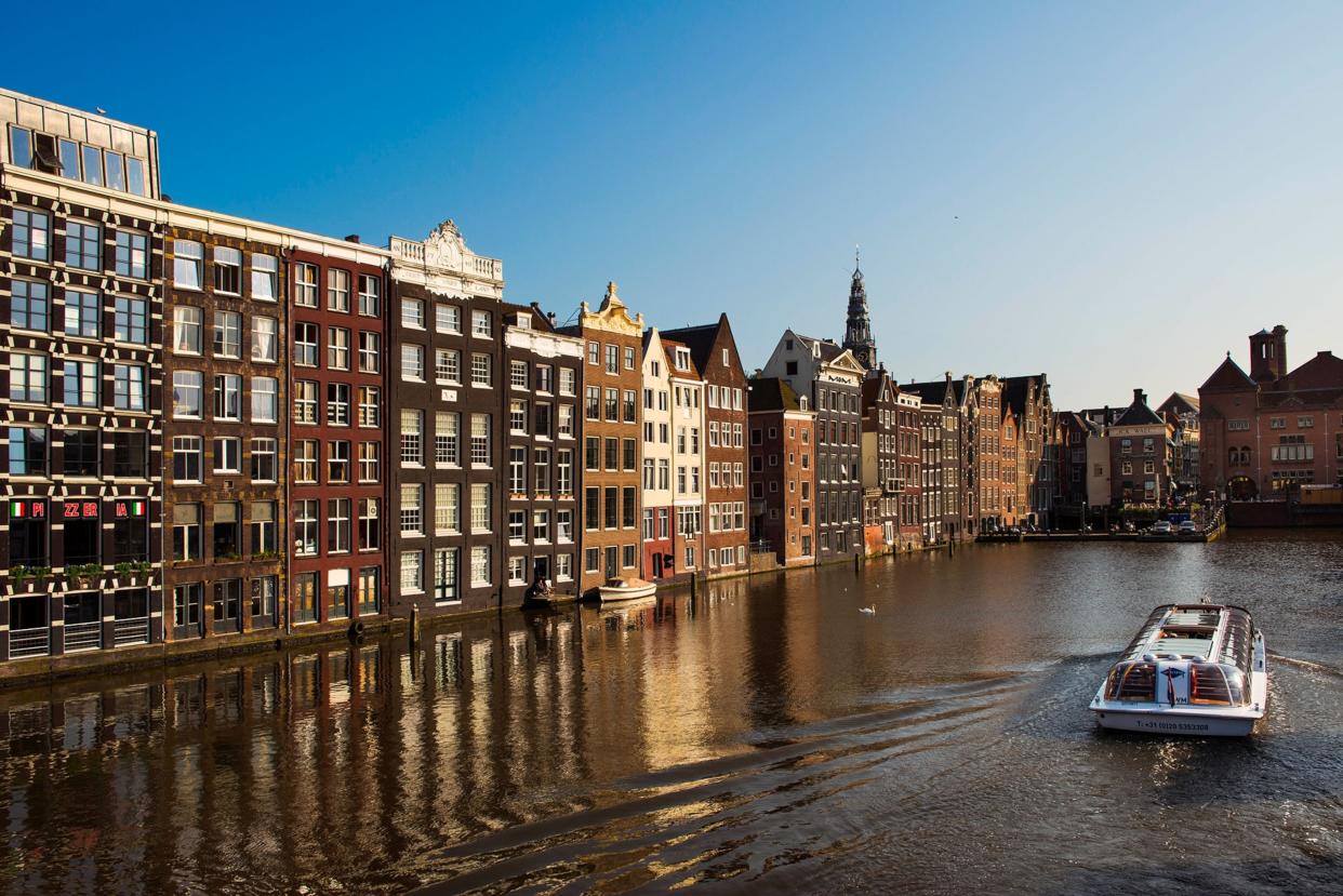 Touring Amsterdam canals, such as the Damrak, by boat is just one of the quintessential ways to explore the Dutch capital.