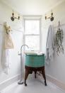 <p>With hanging eucalyptus, an up cycled turquoise sink and fresh linens, this farmhouse bathroom designed by Leanne Ford is beyond dreamy. It also proves that awkwardly-shaped bathrooms can be beautiful with clever layouts. </p>