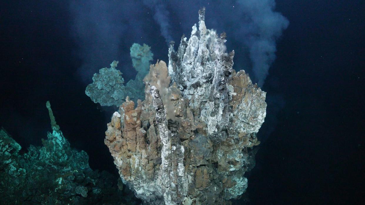 A hyrdothermal vent spewing plumes of liquid into the water.