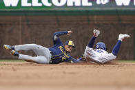 Milwaukee Brewers' Willy Adames, left, tags out Chicago Cubs' Rafael Ortega at second base during the first inning of a baseball game, Thursday, April 7, 2022, in Chicago. (AP Photo/Kamil Krzaczynski)