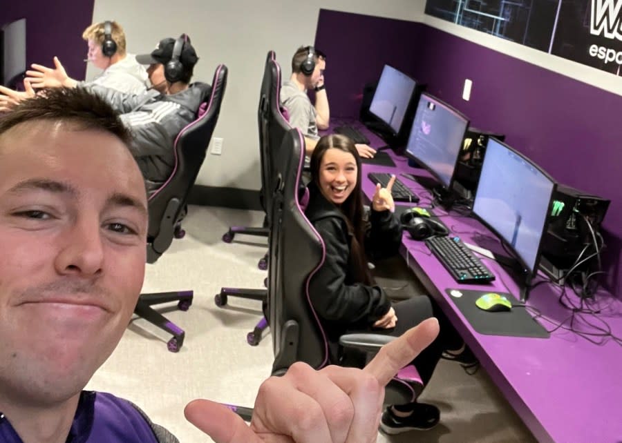 Dr. Bryan Dowdell gestures to the camera as students play video games in Weber State University’s new esports lab. (credit: Bryan Dowdell)