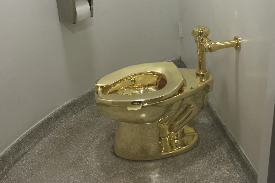 The fully functioning solid gold toilet, made by Italian artist Maurizio Cattelan, at the Guggenheim in 2016. It was stolen from Blenheim Palace in 2019. / Credit: William Edwards/AFP via Getty Images