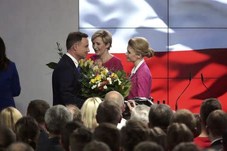 Andrzej Duda, candidate of the conservative opposition Law and Justice (PiS) party stands with his with wife Agata (C) and daughter Kinga (R) as he prepares to make a speech after the announcement of the first exit polls in the first round of the Polish presidential elections, at his election campaign headquarters in Warsaw, Poland May 10, 2015. REUTERS/Slawomir Kaminski/Agencja Gazeta