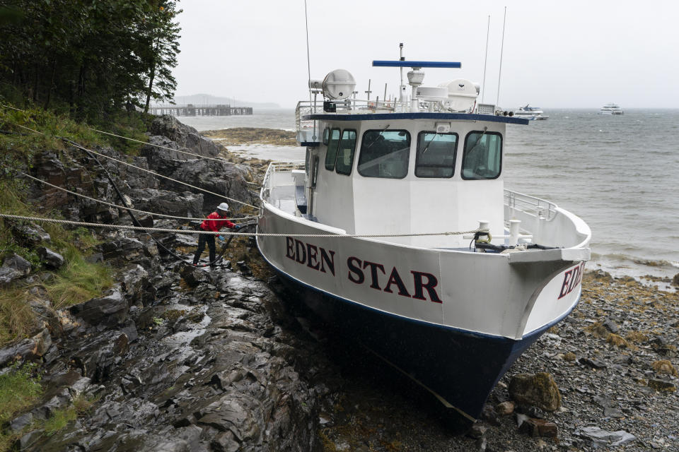 A worker prepares to unload diesel fuel from the Eden Star, a 70-foot tour boat that broke free of its mooring during storm Lee, Saturday, Sept. 16, 2023, in Bar Harbor, Maine, (AP Photo/Robert F. Bukaty)