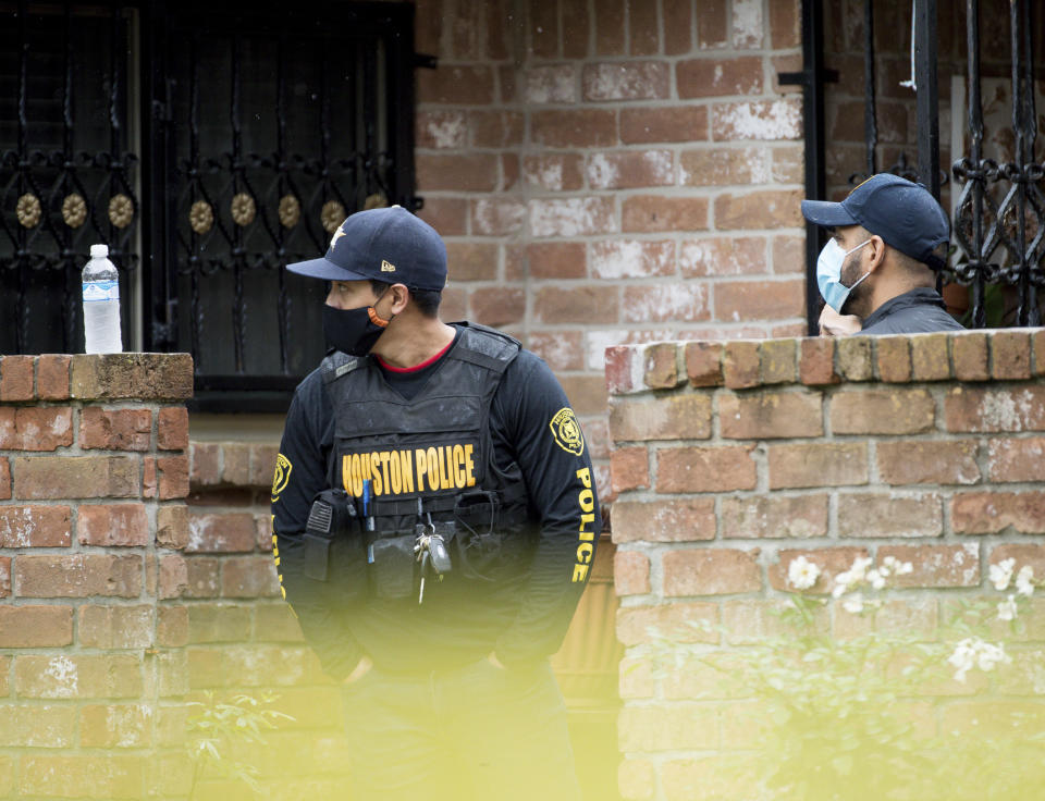 Law enforcement officials investigate a human smuggling case, where more than 90 undocumented immigrants were found inside a home on the 12200 block of Chessington Drive on Friday, April 30, 2021, in Houston. A Houston Police officials said the case will be handled by federal authorities. (Godofredo A. Vásquez/Houston Chronicle via AP)