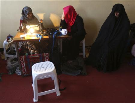 Afghan female prisoners work in a tailoring workshop at Herat prison, western Afghanistan, December 8, 2013. REUTERS/Omar Sobhani