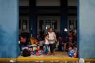 The Wider Image: Venezuelan mothers, children in tow, rush to migrate