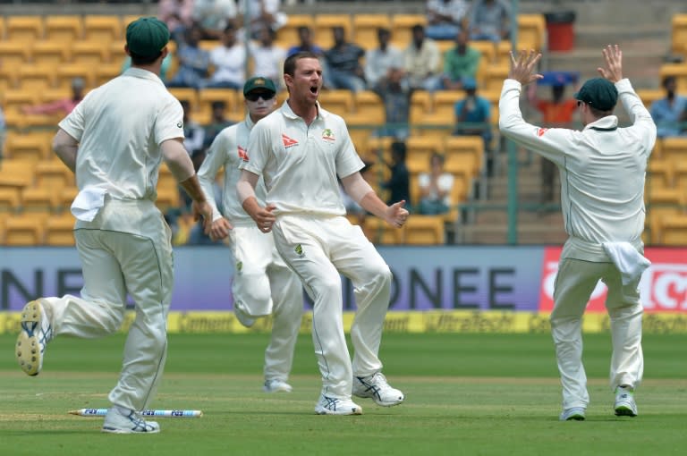 Australia fast bowler Josh Hazlewood (C) celebrates the dismissal of India batsman Abhinav Mukund on the third day of the second Test in Bangalore, on March 6, 2017