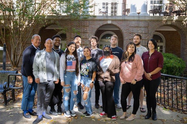 Dr. Osvaldo Di Paolo Harrison (front row, gray), with Maricza Hinnah and Vy Cornett (front row right side) and his class.