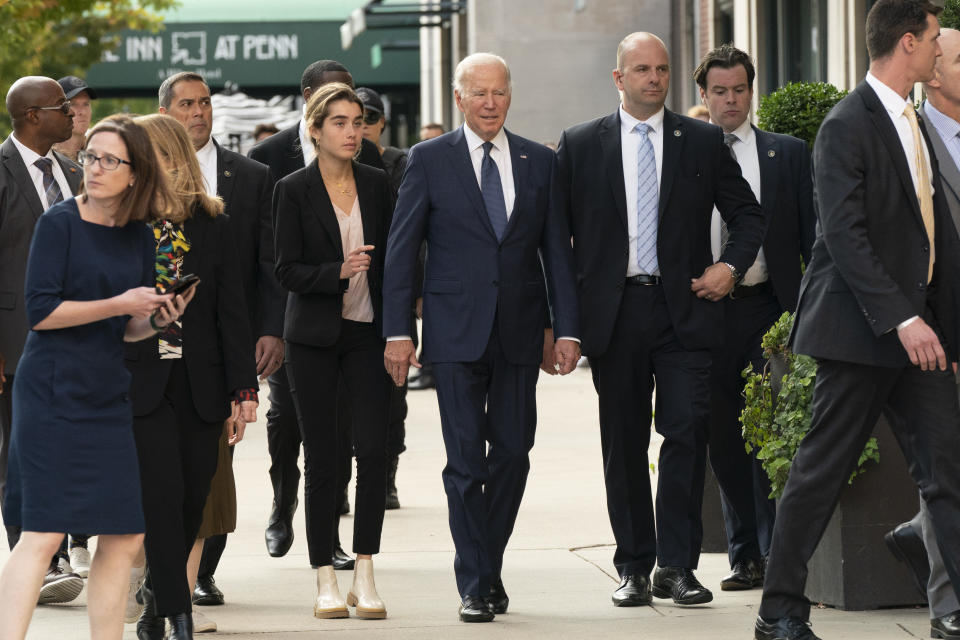 President Joe Biden walks to a University of Pennsylvania bookstore with granddaughter Natalie Biden, left of Biden, Friday, Oct. 7, 2022, in Philadelphia. (AP Photo/Manuel Balce Ceneta)