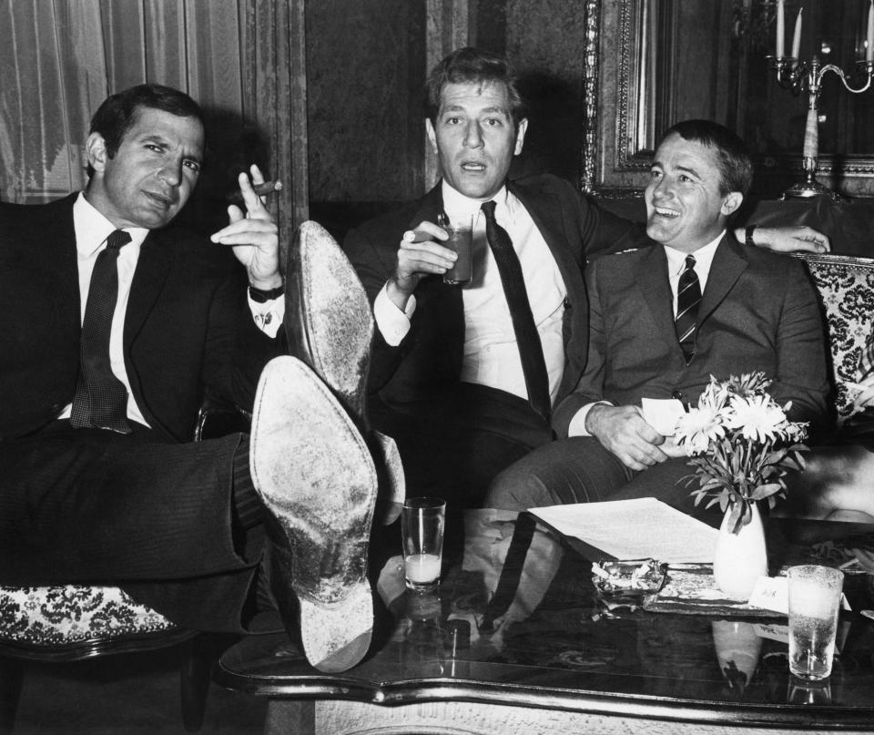 FILE - Actors left to right, Ben Gazzara, George Segal and Robert Vaughn, stars of film "The Bridge at Remagen" relax during press conference at Imperial Hotel in Vienna on Aug. 2, 1968. Segal, the banjo player turned actor who was nominated for an Oscar for 1966's “Who’s Afraid of Virginia Woolf?,” and starred in the ABC sitcom “The Goldbergs,” died Tuesday, his wife said. He was 87. (AP Photo, File)