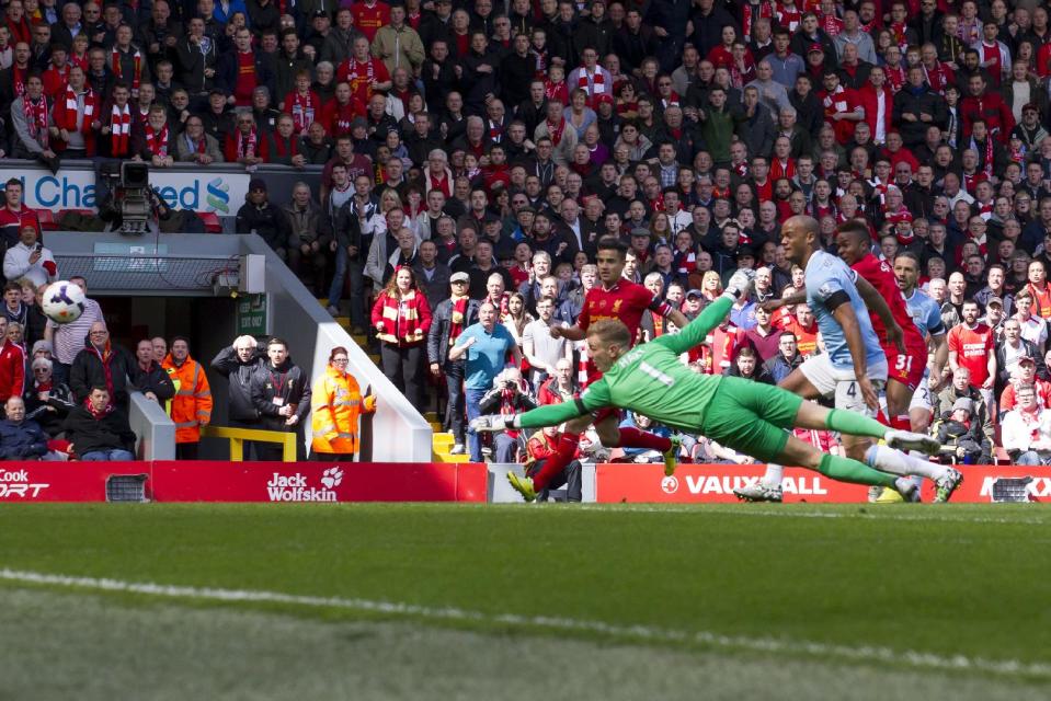 Liverpool's Raheem Sterling, right, scores past Manchester City's goalkeeper Joe Hart, center, during their English Premier League soccer match at Anfield Stadium, Liverpool, England, Sunday April 13, 2014. (AP Photo/Jon Super)