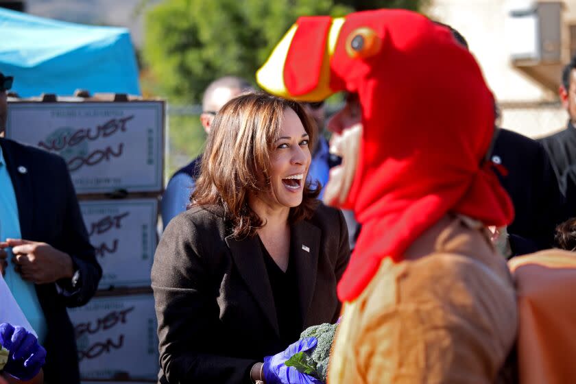 LOS ANGELES, CA - NOVEMBER 23: Vice President Kamala Harris has an interaction with a life size turkey while volunteering handing out brocoli at Big Sunday's 11th Annual Thanksgiving Stuffing Event at Baldwin Hills Elementary School on Wednesday, Nov. 23, 2022 in Los Angeles, CA. The Big Sunday organization will host its 11th annual ``Big Thanksgiving Stuffing Event -- a Festival of Gratitude.'' More than 1,500 volunteers will sort food and hand out bags of food to families in need. (Gary Coronado / Los Angeles Times)