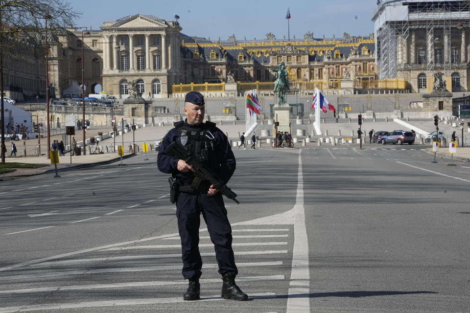 A police officer patrols in front of the Chateau de Versailles, where a European Union summit will take place, Thursday, March 10, 2022 in Versailles, west of Paris. With European nations united in backing Ukraine's resistance with unprecedented economic sanctions, three main topics now dominate the agenda: Ukraine's application for fast-track EU membership; how to wean the bloc off its Russian energy dependency; and bolstering the region's defense capabilities. (AP Photo/Michel Euler)