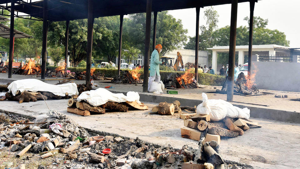 Bodies, pictured here at a crematorium in New Delhi, India.