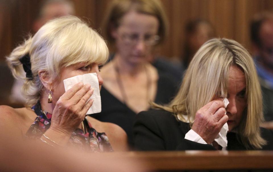 June Steenkamp, right, mother of the late Reeva Steenkamp, and family friend, Jenny Strydom, left, react during the murder trial of Oscar Pistorius, during cross questioning on mobile phone text messages between Pistorius and Steenkamp, in court in Pretoria, South Africa, Tuesday, March 25, 2014. Pistorius is charged with the Valentines Day 2013 shooting death of his girlfriend Reeva Steenkamp. (AP Photo/Siphiwe Sibeko, Pool)