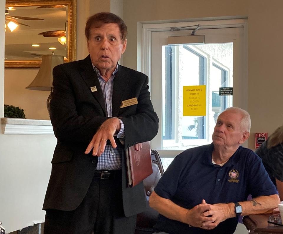 Daytona Beach Shores Councilman Richard Bryan speaks to condo owners and government officials at the Dimucci Twin Towers south tower on Monday, as Dimucci Twin Towers board member Ed Offerman watches.