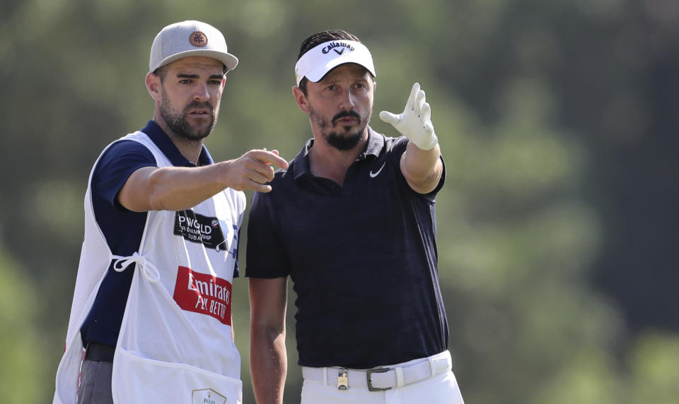 Mike Lorenzo-Vera, of France, talks to his caddie on the 3rd hole during the second round of the DP World Tour Championship golf tournament in Dubai, United Arab Emirates, Friday, Nov. 22, 2019. (AP Photo/Kamran Jebreili)