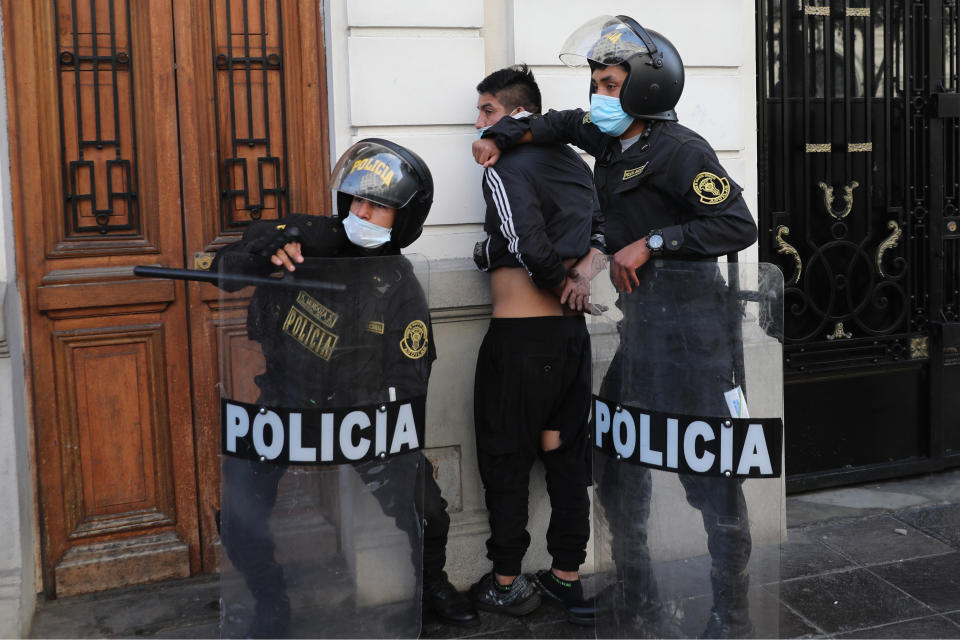 Police detain a protester near Congress where lawmakers swore-in a new president after voting to oust President Martin Vizcarra the day before, in Lima, Peru, Tuesday, Nov. 10, 2020. Peru swore in businessman and head of Congress Manuel Merino Tuesday who is unknown to most and was recently accused of trying to secure the military’s support for a congressional effort to boot the nation’s last leader out over unproven corruption allegations. (AP Photo/Rodrigo Abd)