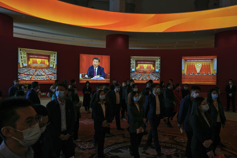 FILE - Visitors wearing face masks tour an exhibition highlighting President Xi Jinping and his China's achievements under his leadership at the Beijing Exhibition Hall in the capital city where the 20th Party Congress will be held in Beijing on Oct. 12, 2022. When Xi Jinping came to power in 2012, it wasn't clear what kind of leader he would be. His low-key persona during a steady rise through the ranks of the Communist Party gave no hint that he would evolve into one of modern China's most dominant leaders, or that he would put the economically and militarily ascendant country on a collision course with the U.S.-led international order. (AP Photo/Andy Wong, File)