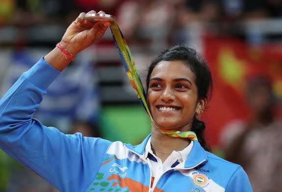 Sindhu Pusarla V. of India celebrates her silver medal on the medal stand after the Rio 2016 Olympic Games Women's Badminton Singles at the Riocentro in Rio de Janeiro, Brazil, 19 August 2016.