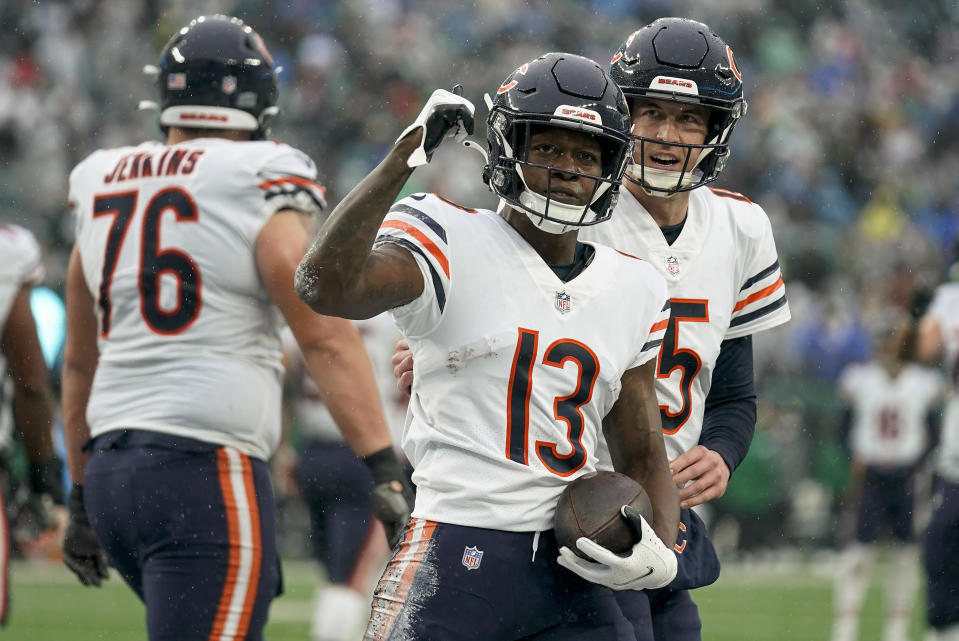 Chicago Bears wide receiver Byron Pringle (13) celebrates with quarterback Trevor Siemian (15) after scoring a touchdown against the New York Jets during the first quarter of an NFL football game, Sunday, Nov. 27, 2022, in East Rutherford, N.J. (AP Photo/Seth Wenig)