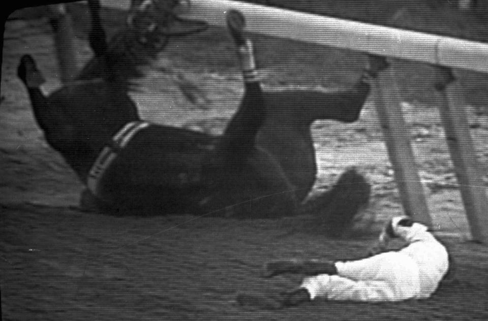 FILE - Go For Wand and jockey Randy Romero hit the dirt during the final stretch of the Breeders' Cup Distaff at Belmont Park in New York on Oct. 27, 1990. Go For Wand was leading by a head at the sixteenth pole when she suffered an open fracture to her right cannon bone. She fell to the track and threw jockey Randy Romero to the ground before rising to limp on three legs. Track personnel caught her and got her to lie down, and she was euthanized on the track. (AP Photo/Mike Albans, file)