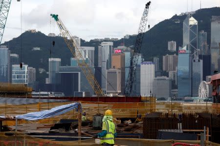 A worker stands on a construction site as part of the West Kowloon Terminus project for the Guangzhou-Shenzhen-Hong Kong Express Rail Link in Hong Kong, China July 21, 2017. REUTERS/Bobby Yip