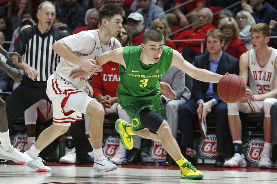 Oregon guard Payton Pritchard (3) drives around Utah guard Rylan Jones, left, in the second half during an NCAA college basketball game Saturday, Jan. 4, 2020, in Salt Lake City. (AP Photo/Rick Bowmer)