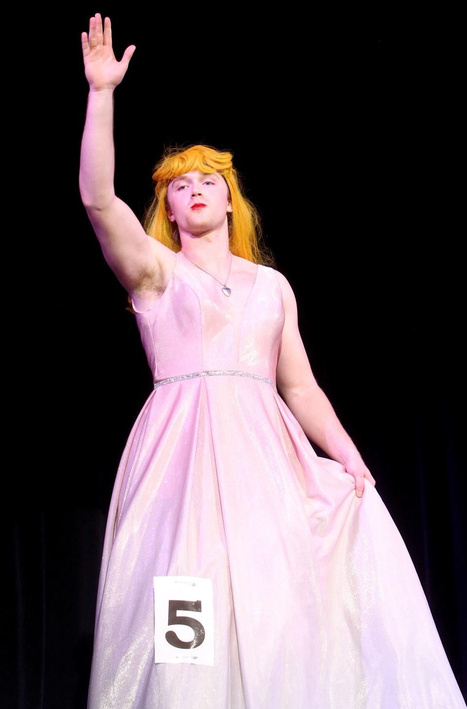 Contestant #5, Tyson Patterson waves to the crowd during the Individual Costume portion of Mr. BNL held Friday, March 31, 2023. Patterson won the Best Costume Award.