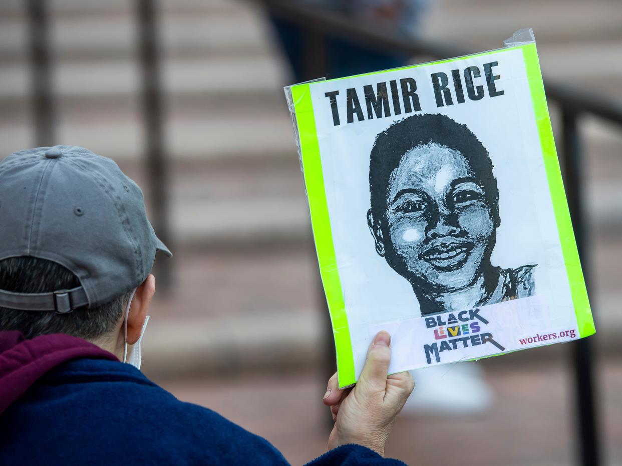 A supporter holds a sign on Tuesday, November 9, 2021, in Cleveland, during a rally for Tamir Rice.